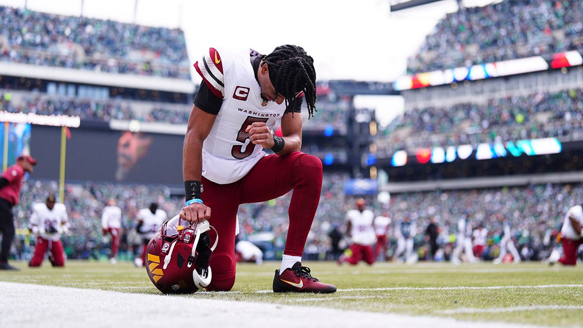 Jayden Daniels prays before the match