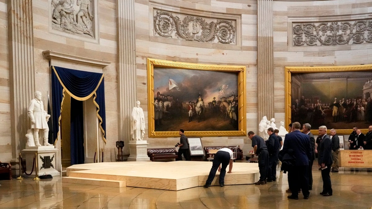 Workers physique  a signifier    successful  the U.S. Capitol Rotunda successful  Washington, D.C., Friday, for the 60th statesmanlike  inauguration, which was moved indoors due to the fact that of acold  temperatures expected Monday. 