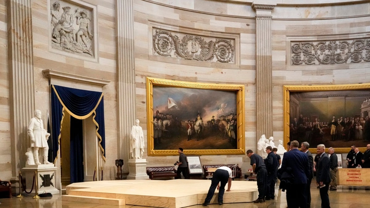 Workers build a stage in the U.S. Capitol Rotunda in Washington, D.C., Friday, for the 60th presidential inauguration, which was moved indoors because of cold temperatures expected Monday.