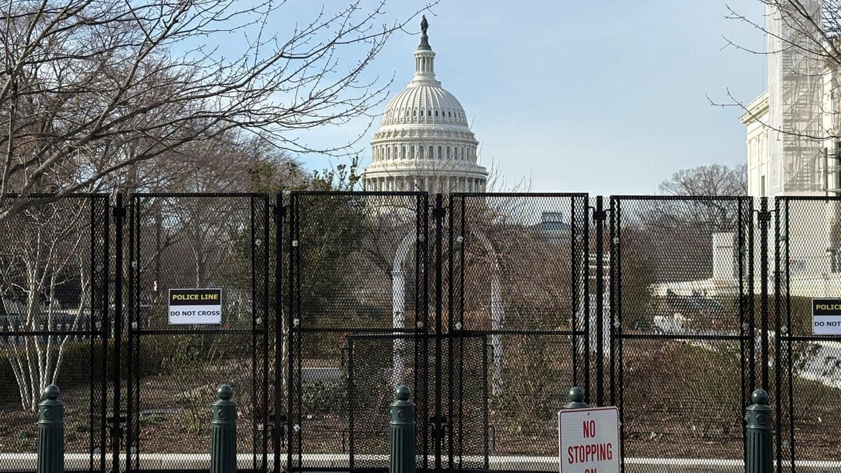 The US Capitol building is surrounded by a fence