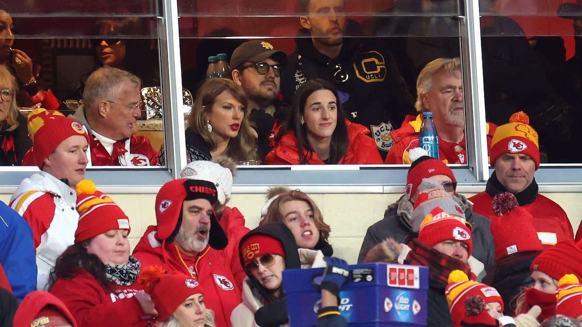 Singer-songwriter Taylor Swift (L) talks with Caitlin Clark (R) of the Indiana Fever during the second half in the AFC Divisional Playoff between the Houston Texans and the Kansas City Chiefs at GEHA Field at Arrowhead Stadium on January 18, 2025 in Kansas City, Missouri. 