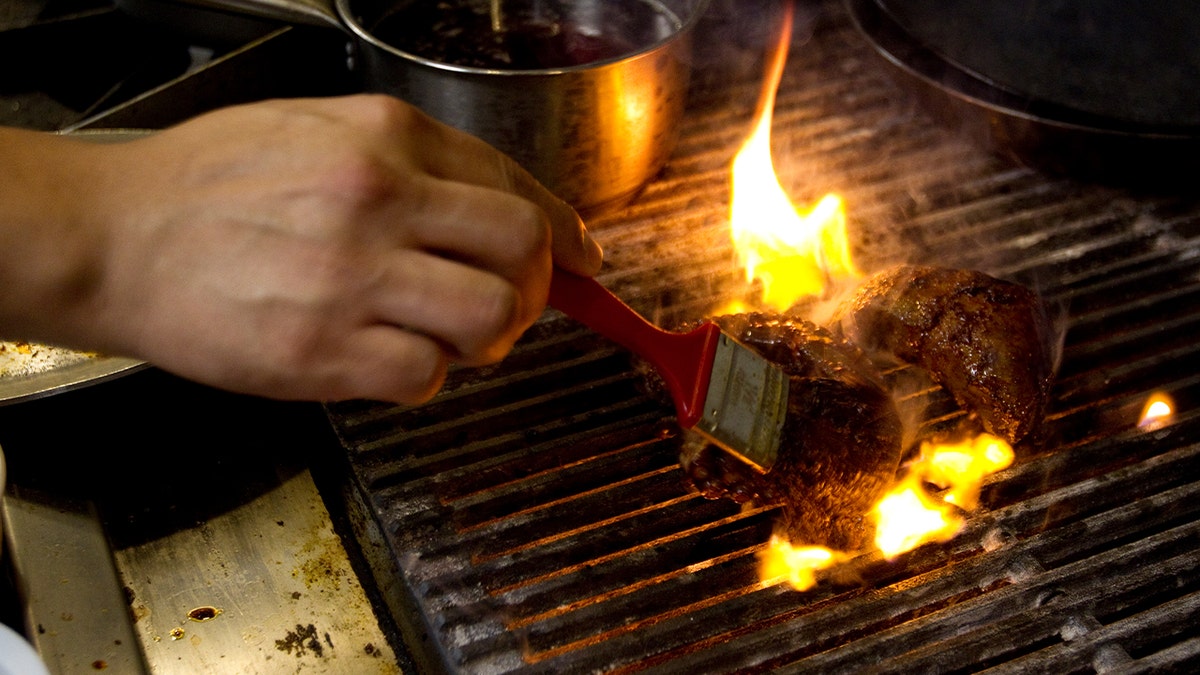 Chef David Guerrero prepares char-grilled octopus and beef heart at Alma Cebiche bar Monday, Dec. 17, 2012, in Houston.