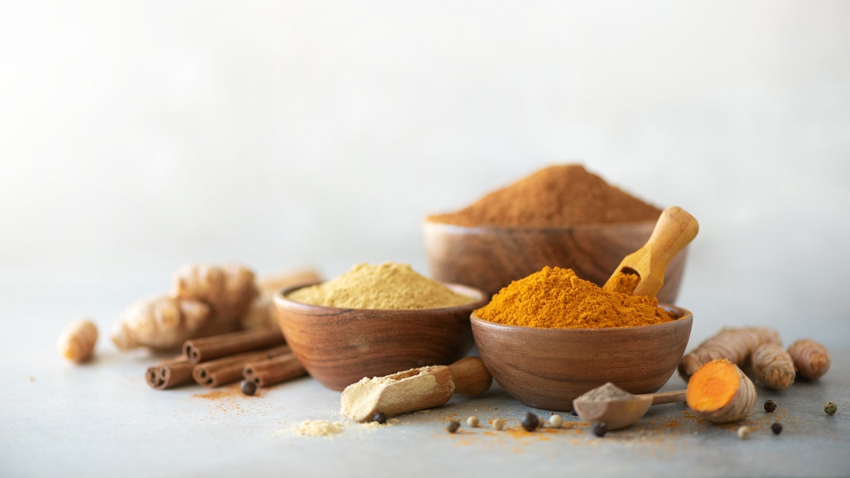 Cinnamon and tumeric are spices in bowls.