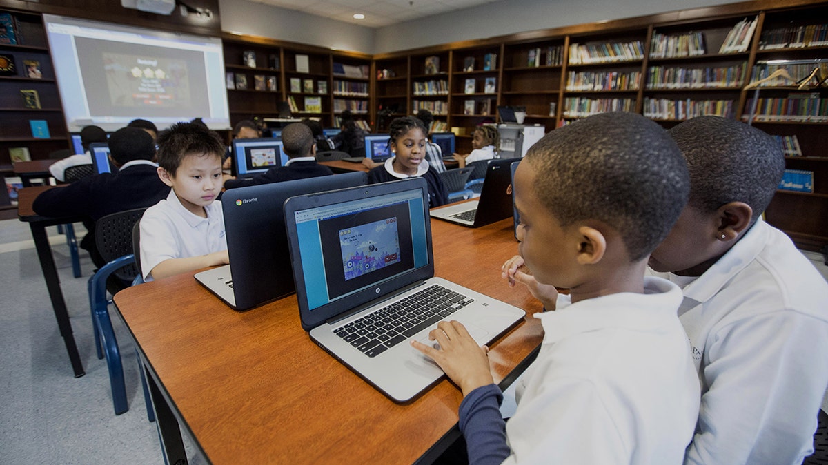 Third graders working on computers