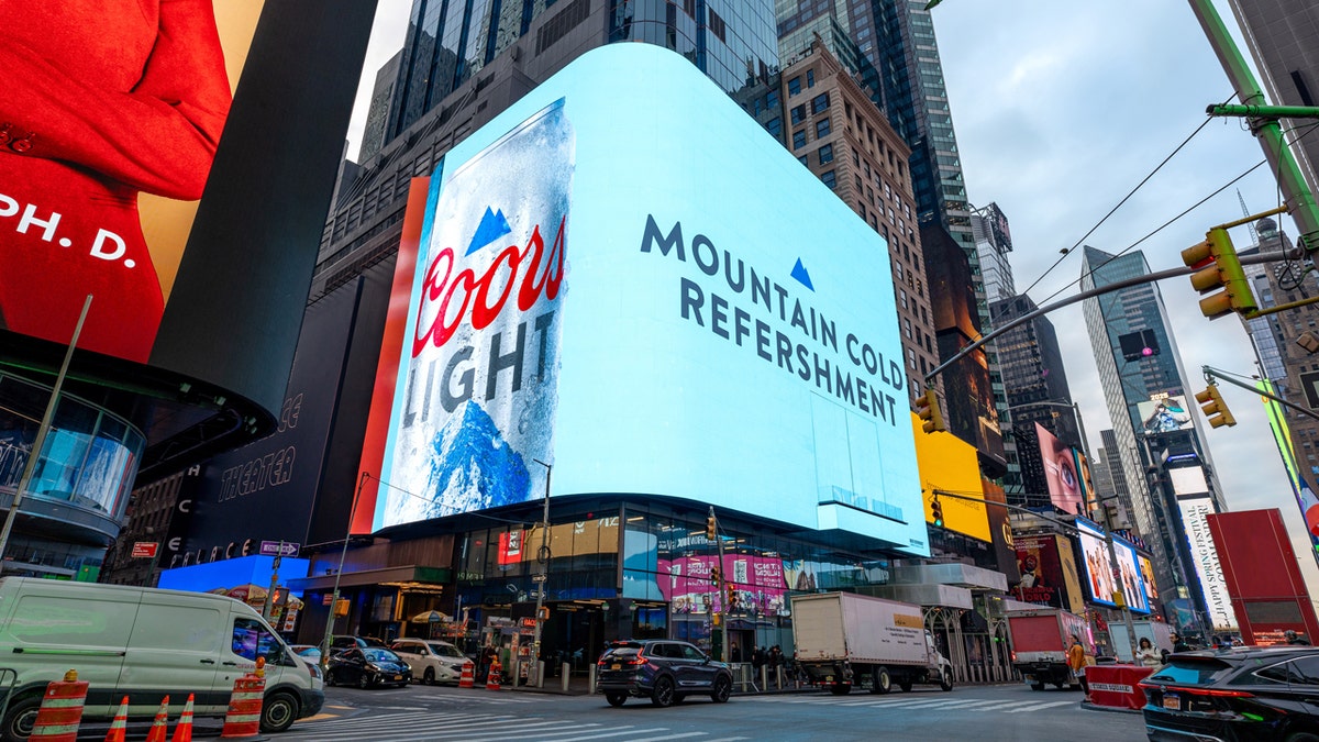 A billboard in New York City's Times Square displays a Coors Light ad with the misspelled slogan: "Cold mountain refreshments."