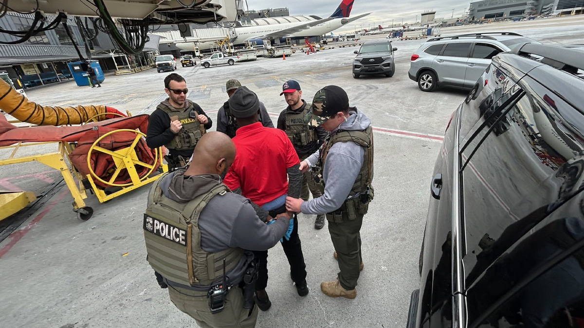 A antheral   accused of migration  transgression  is connected  an Atlanta tarmac awaiting a deportation flight