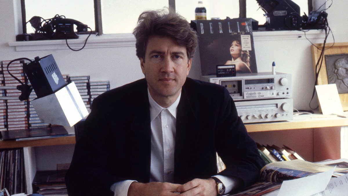 David Lynch sitting at a desk