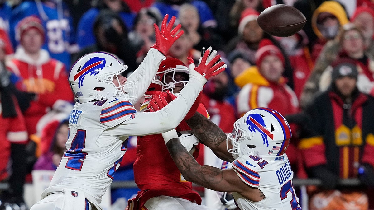 Xavier Worthy jumps to the ball