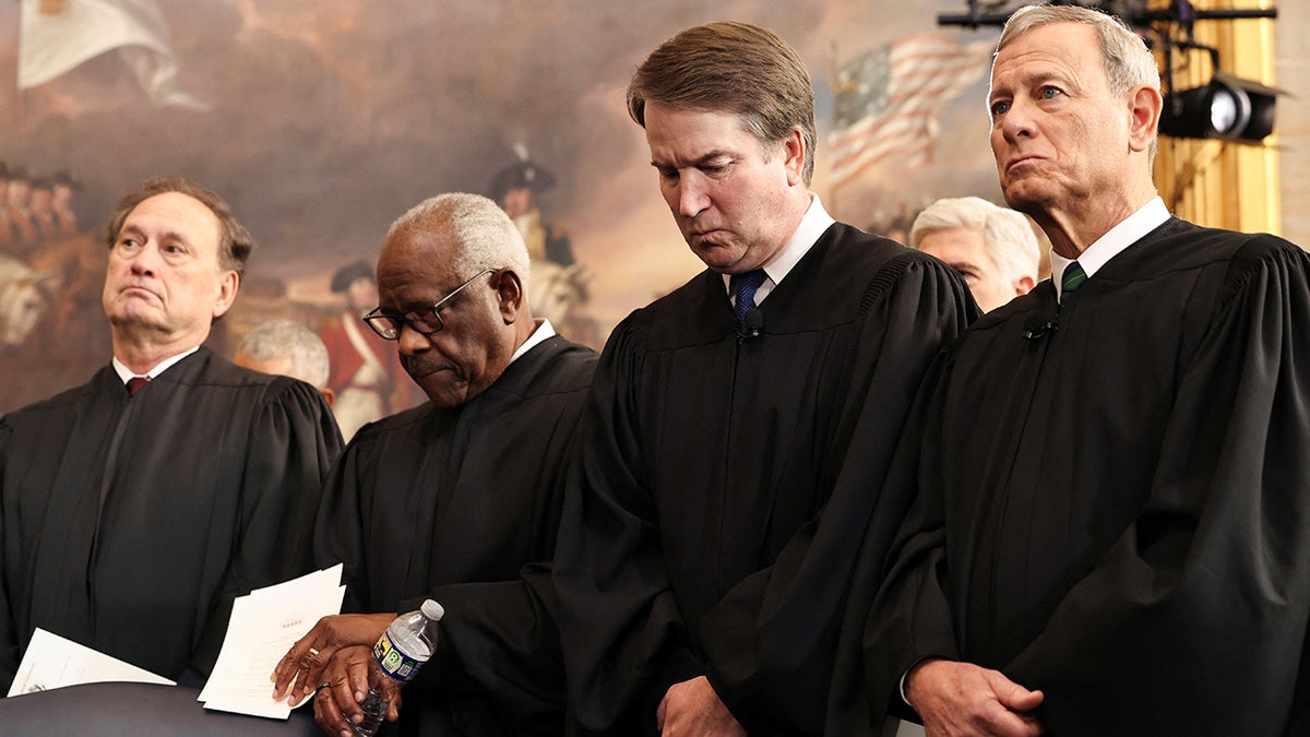 U.S. Associate Supreme Court Justices Samuel Alito, Jr., Clarence Thomas and Brett Kavanaugh and U.S. Supreme Court Chief Justice John Roberts look on during inauguration ceremonies