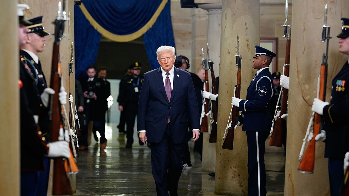 Donald Trump at the opening is surrounded by military honor guards