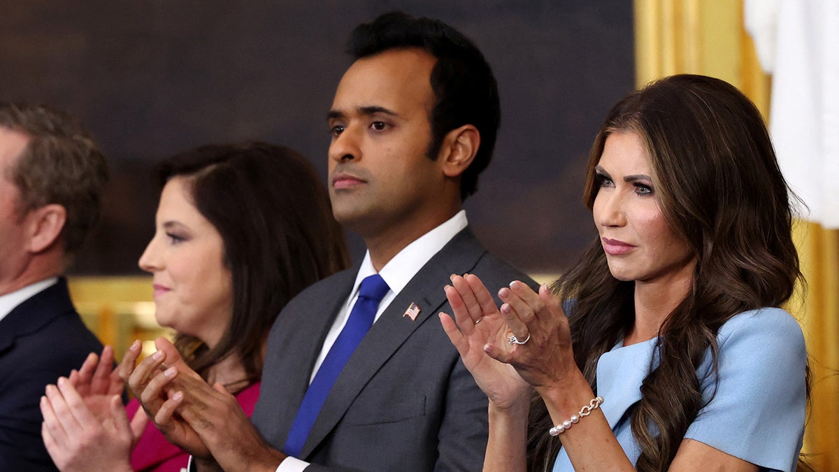 Vivek Ramaswamy and Kristi Noem applaud at US President Donald Trump's inauguration ceremony.