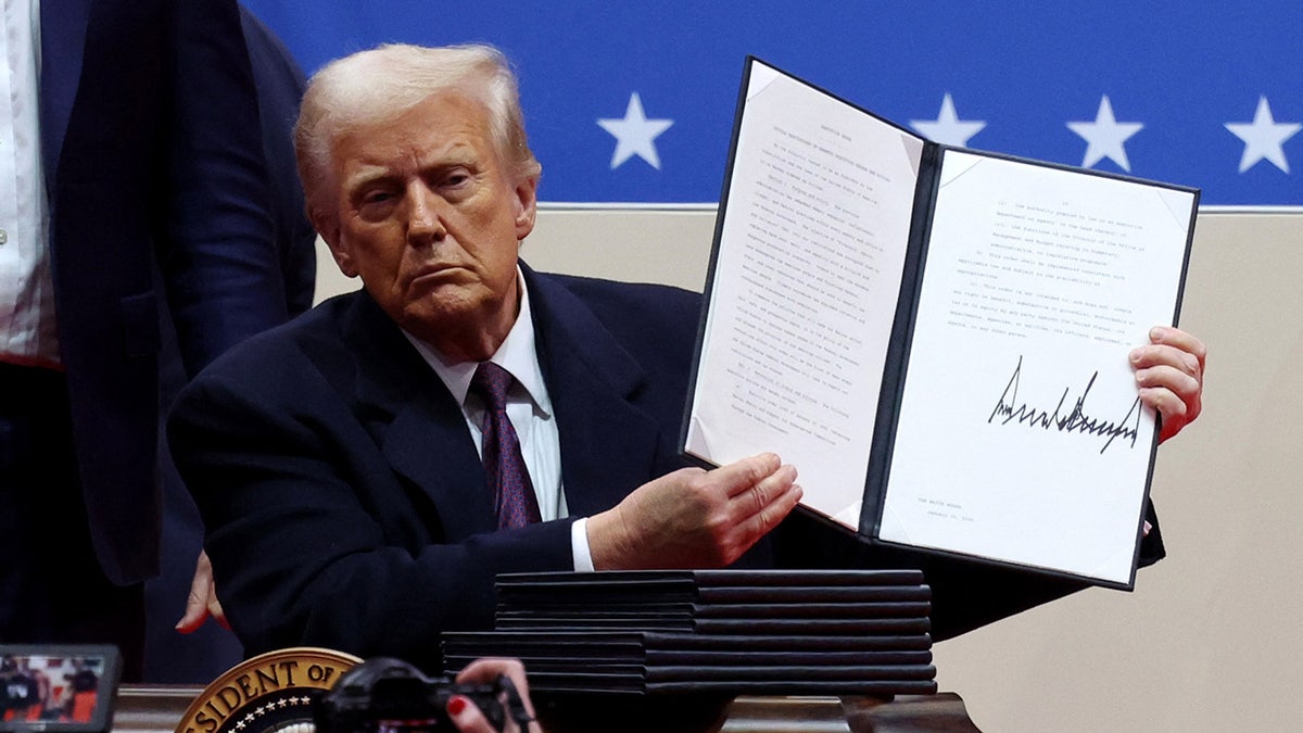 US President Donald Trump appears signing an executive order