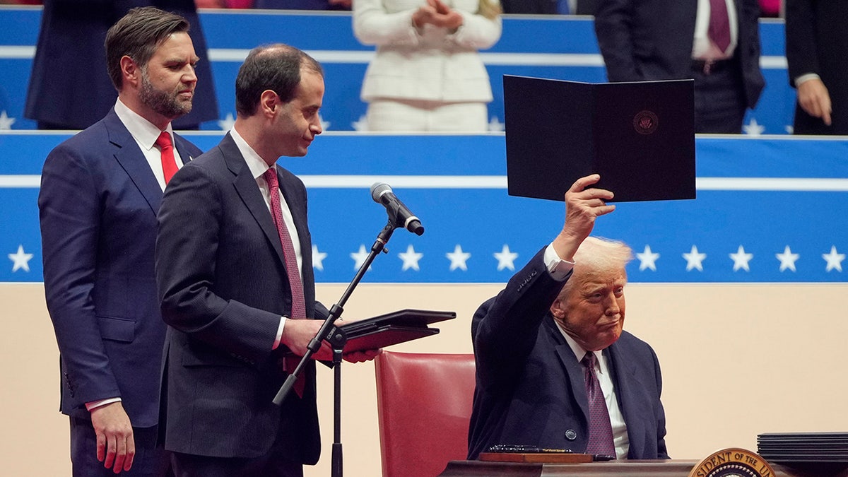 Trump en el escenario Firma de órdenes ejecutivas