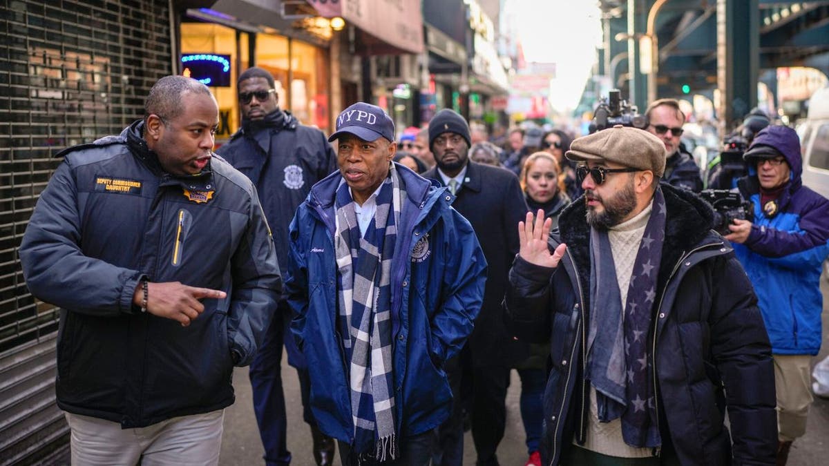 New York City Mayor Eric Adams walks in Queens with police