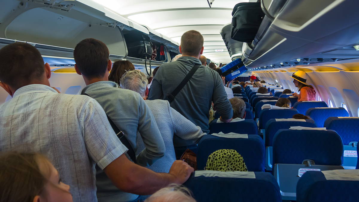 flight passengers crowding plane