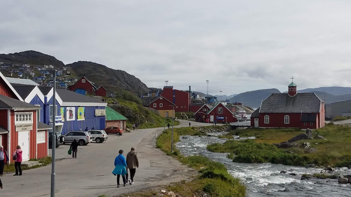 A town in Greenland with homes and a road