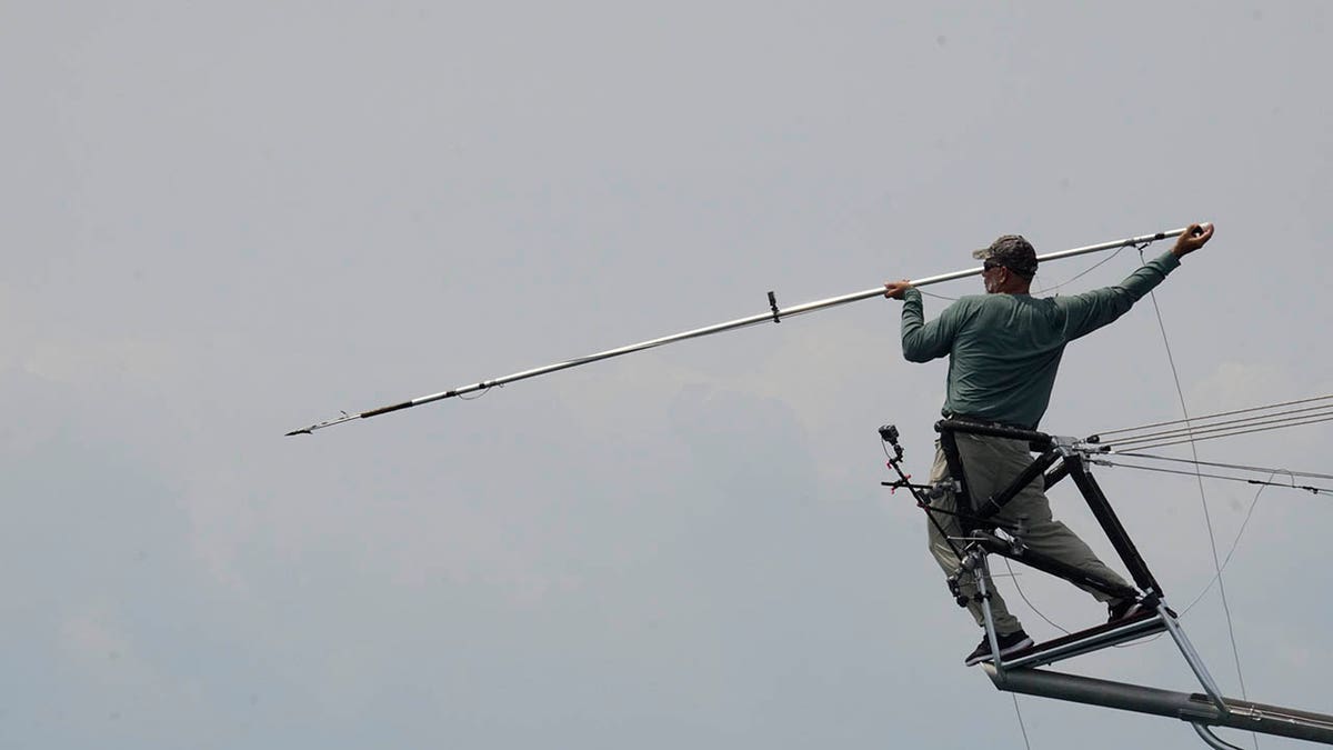 Cynthia C2 Capt. Tyler Macallister on the pulpit, throwing a harpoon. 