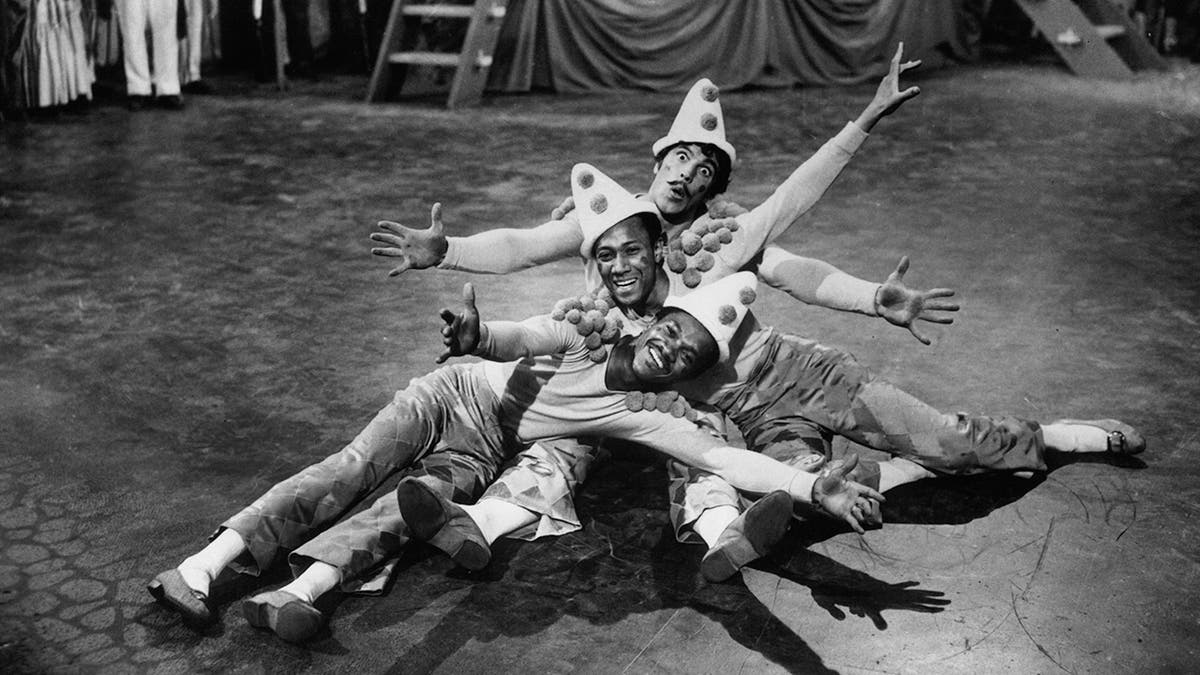 The Nicholas Brothers and Gene Kelly performing on stage 