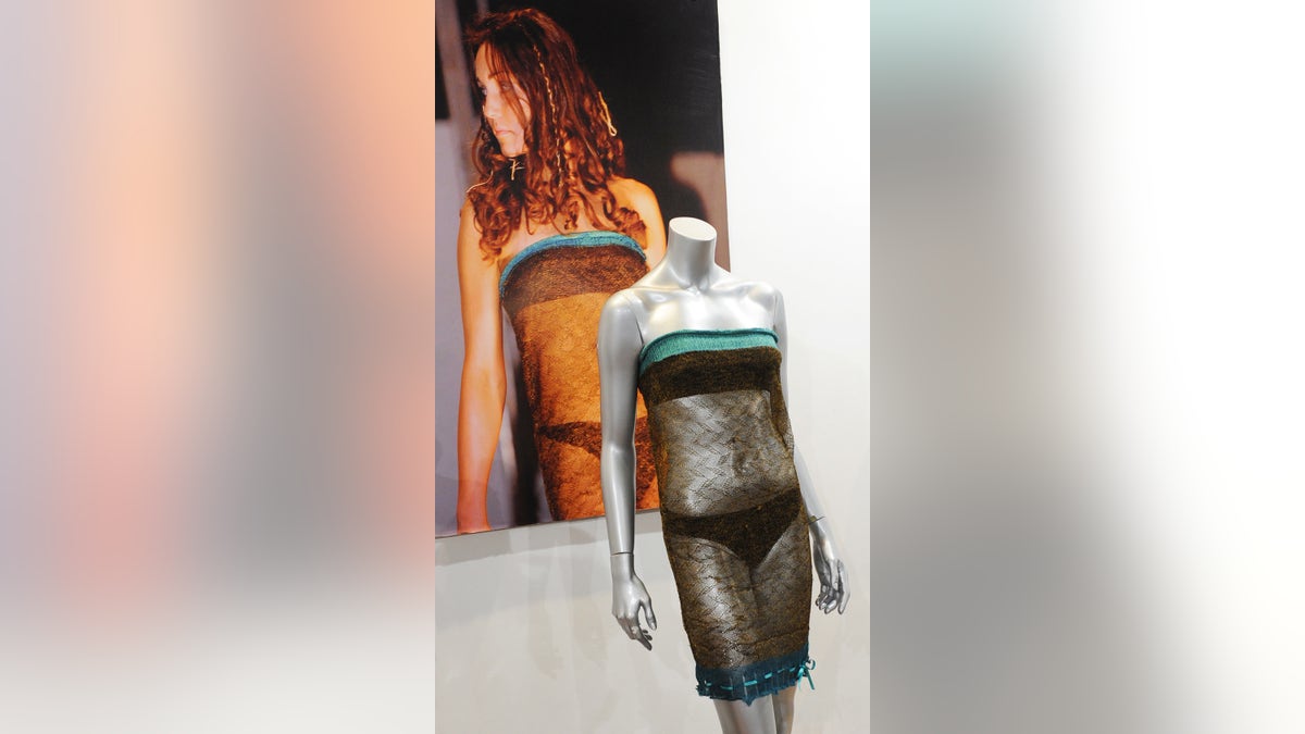A mannequin wearing Kate Middleton's runway fashion next to a photo of her.