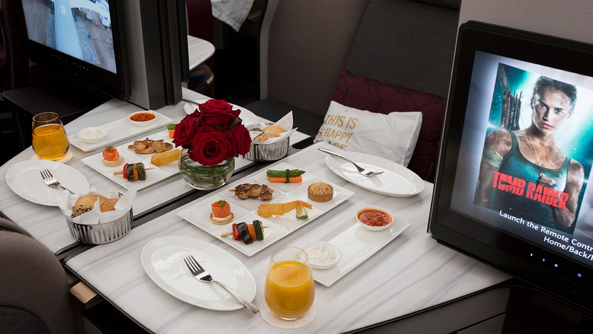 Business Class meals and luxury seating in a Qatar Airways Airbus A350-1000.