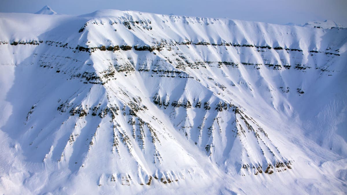 Snow-covered mountains with a height of up to 1,000 meters can be seen near the research station Kings Bay in Ny-Alesund on Spitsbergen Island, Norway, on April 10, 2015. Arctic research stations of China, Norway, Germany, and France, manned throughout the year, are now operating on the grounds of the former mining site on the Svalbard archipelago.