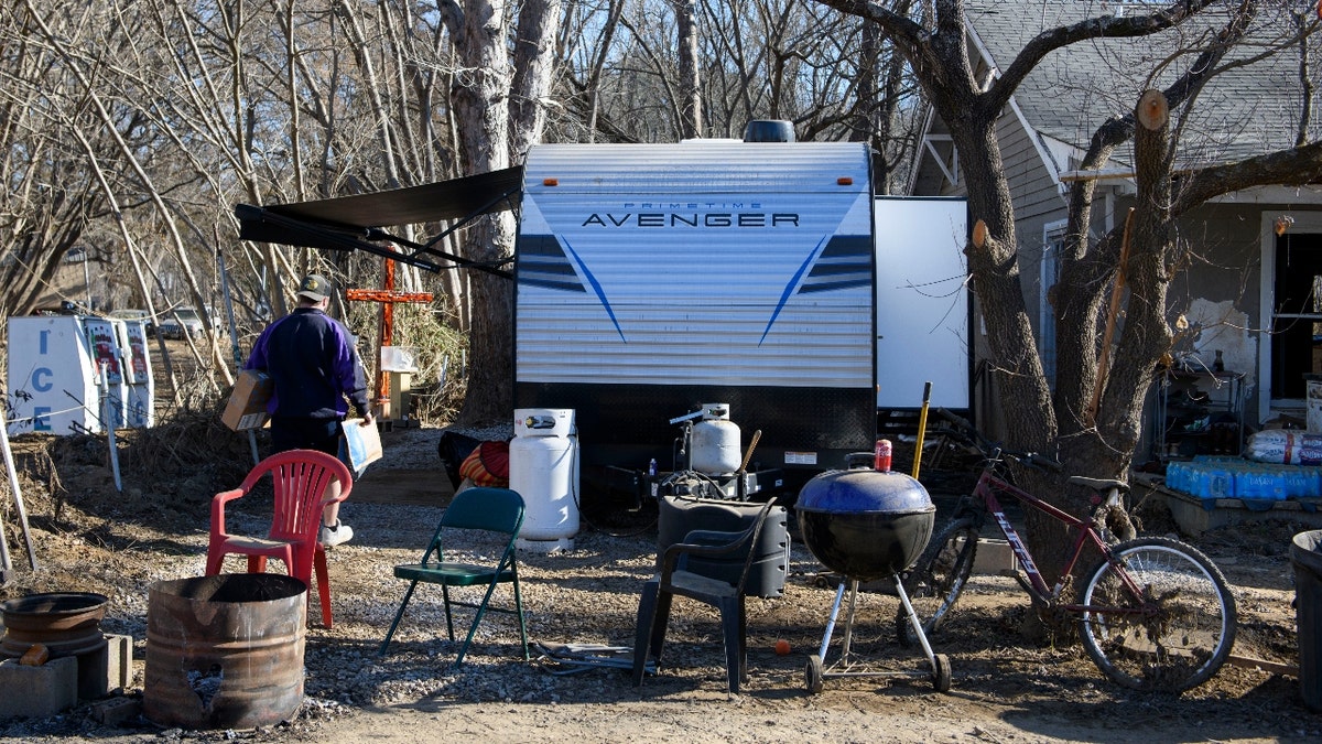  A Fed Ex worker delivers packages to a trailer on December 23, 2024 in Old Fort, North Carolina. The trailer was given to the marine veteran from the Department of Veterans Affairs. 