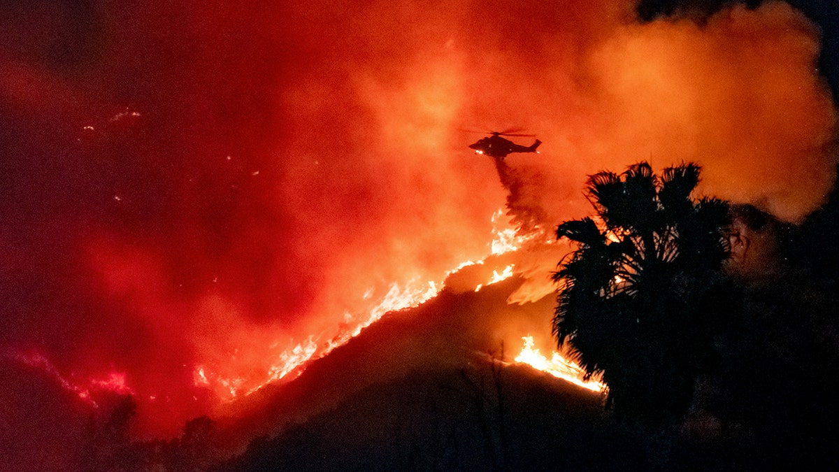 Helicopter makes a water drop during the Sunset Fire in LA.