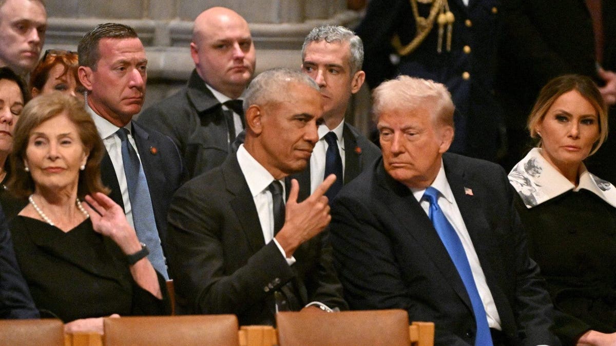 Former US President Barack Obama speaks with President-elect Donald Trump with Sean Curran successful  the background