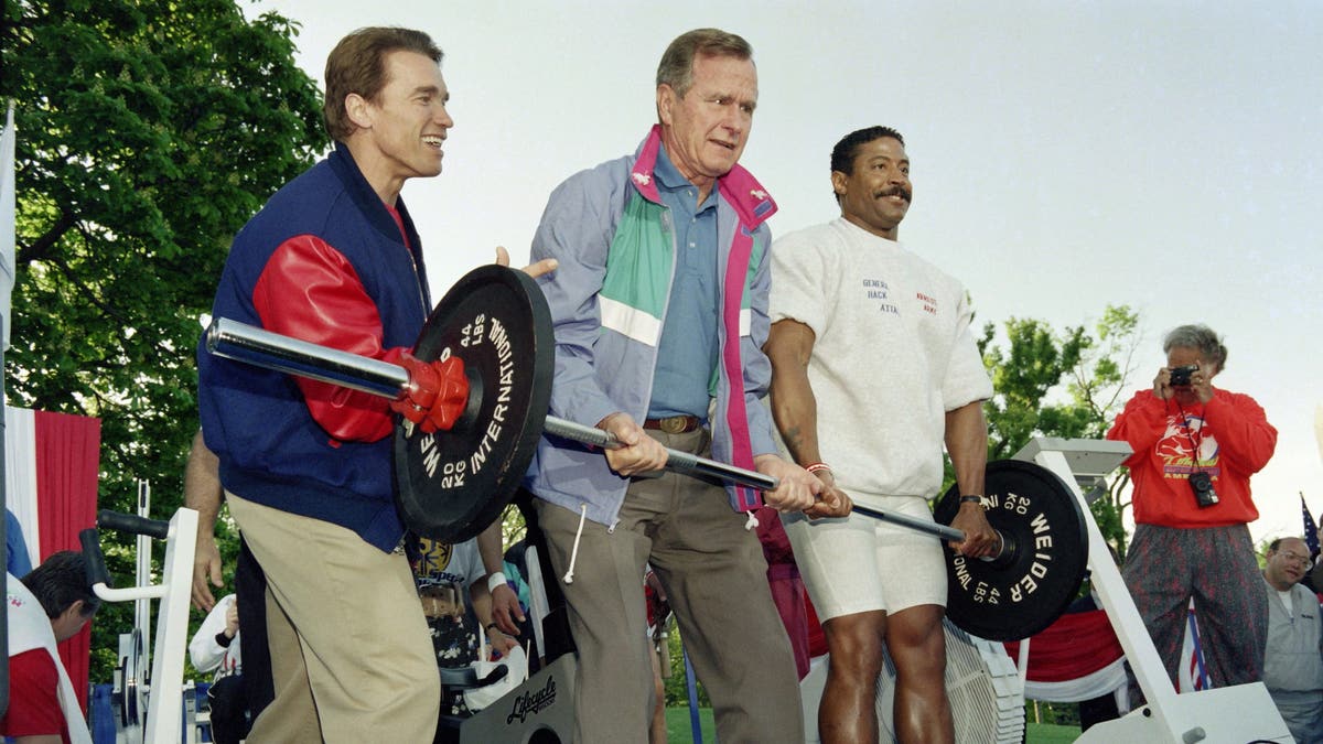 george bush lifting weights with arnold schwarzenegger at an event