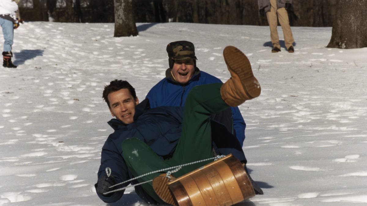 arnold schwarzenegger sledding with george h.w. bush