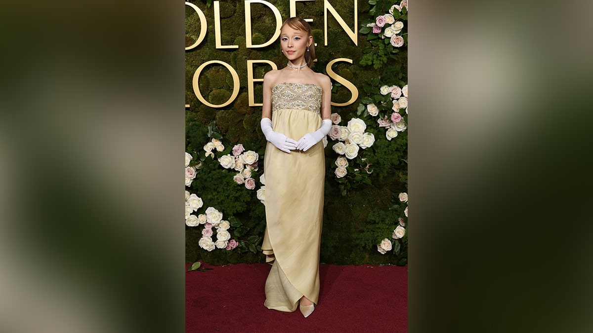 Ariana Grande paid homage to the Yellow Brick Road in a yellow dress on the Golden Globes red carpet.