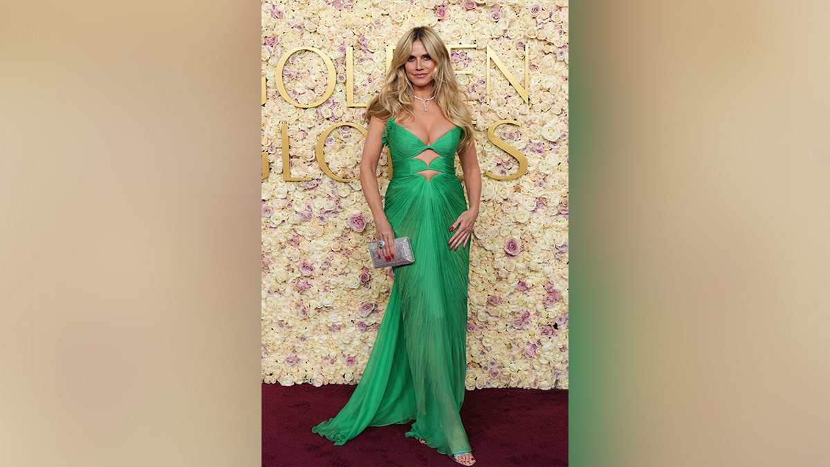 Heidi Klum walked the carpet at the 2025 Golden Globe Awards in a green cutout dress.