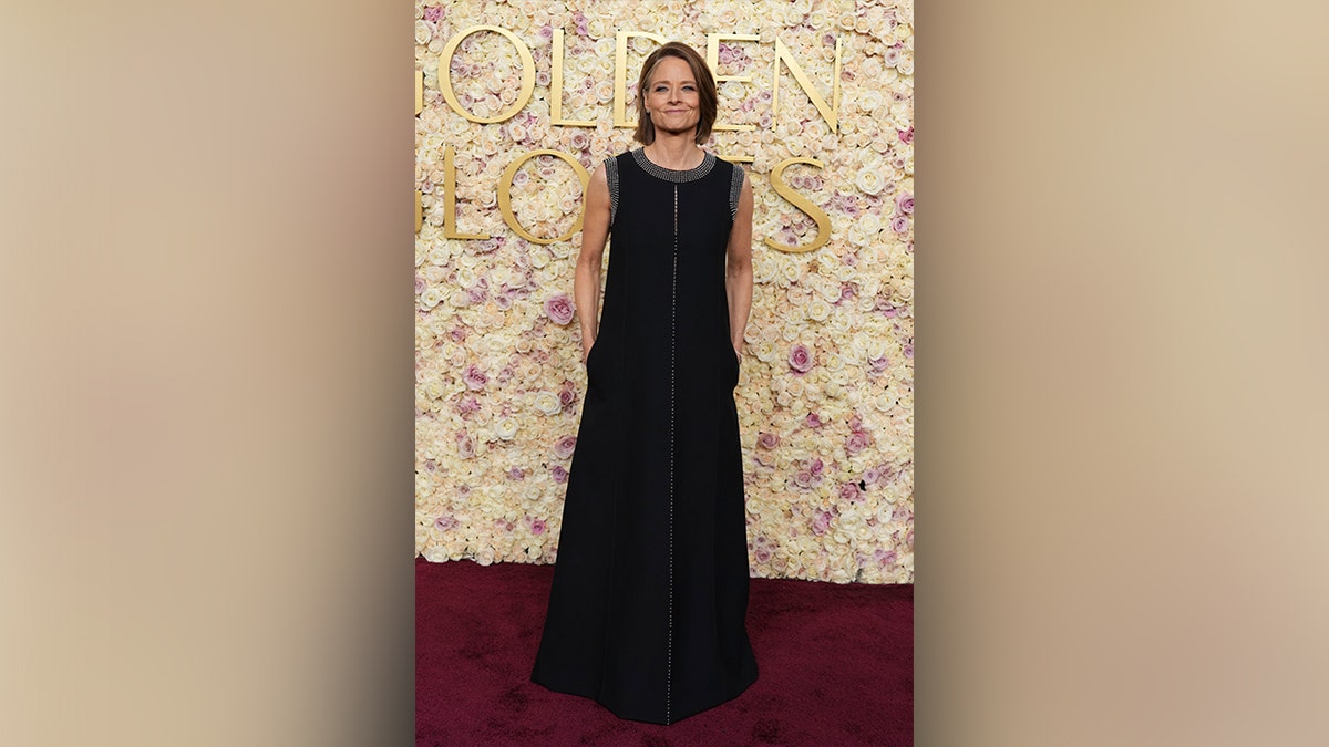 Jodie Foster posed for photos in a black gown with white accents.