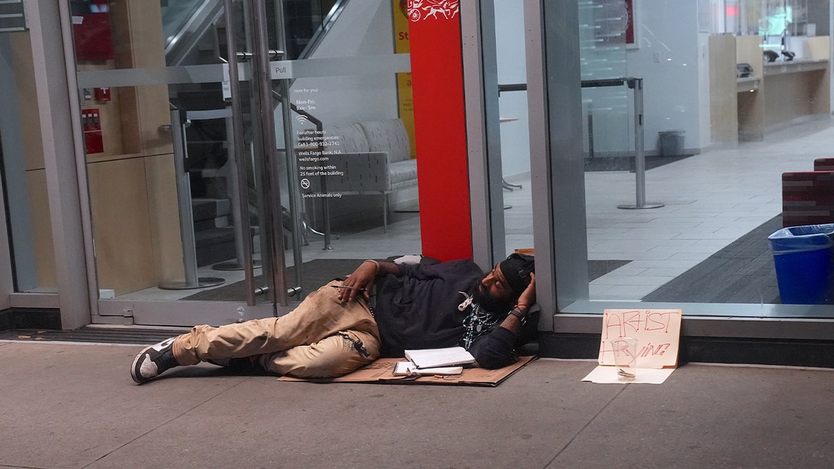 Homeless person lying on the sidewalk