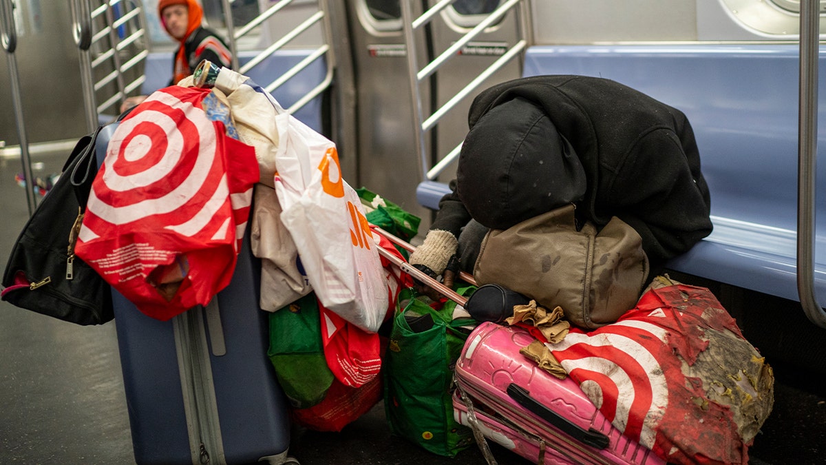 Homeless man with belongings in subway