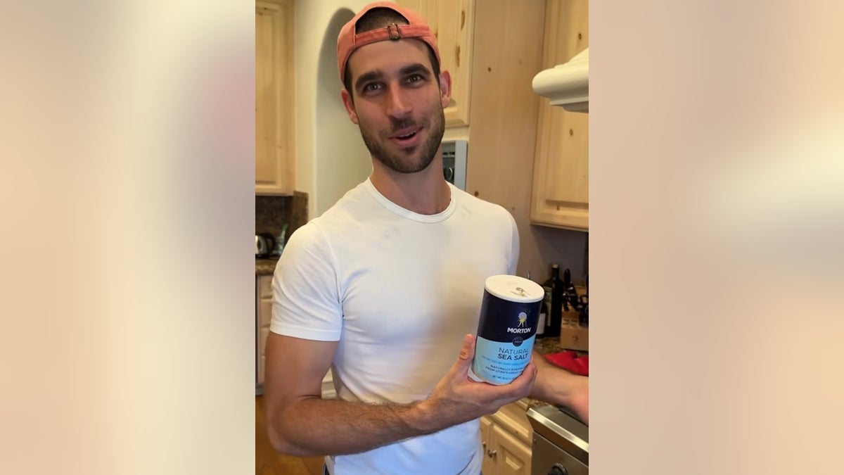 Vanna White's son Nikko holds a can of salt 