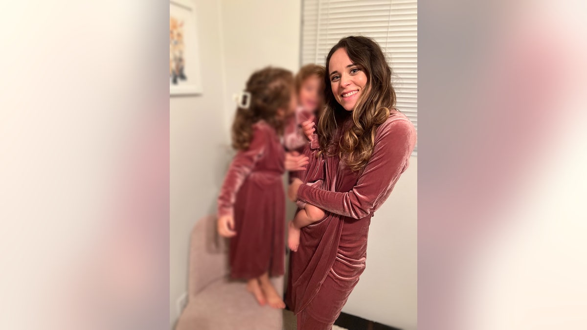 Jinger Duggar Vuolo wearing a matching pink dress with her daughters.