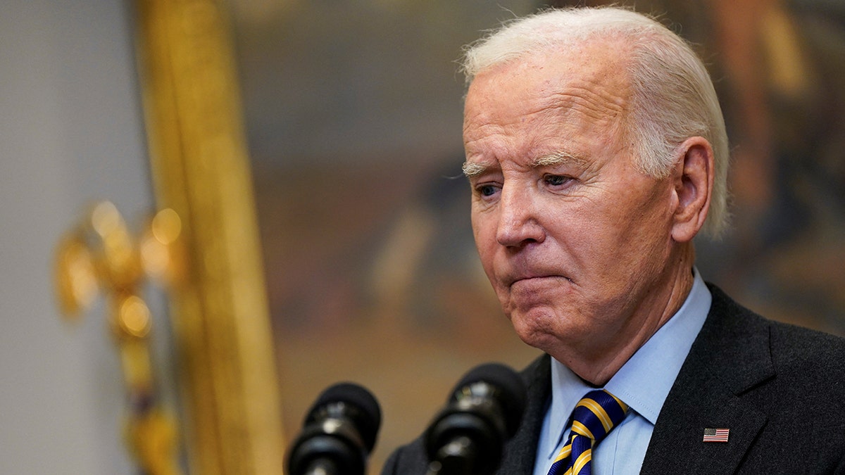 Joe Biden looks down while speaking at the White House