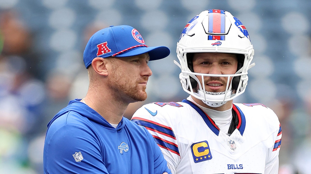 Joe Brady stands next to Josh Allen