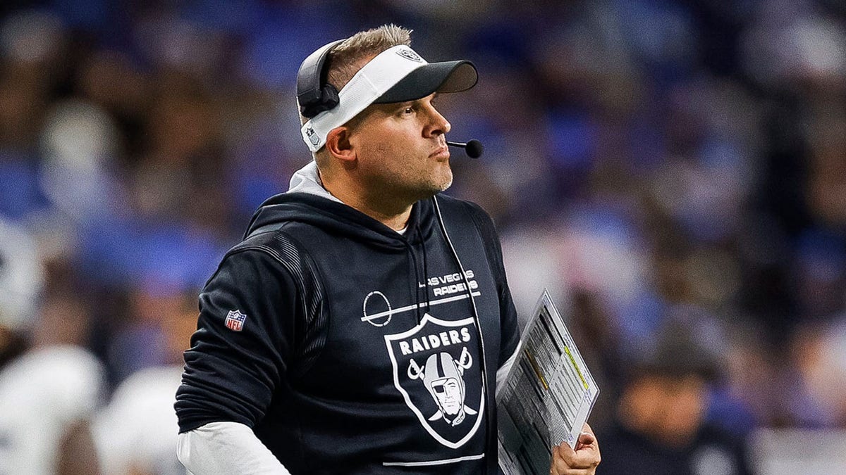 Josh McDaniels looks on field