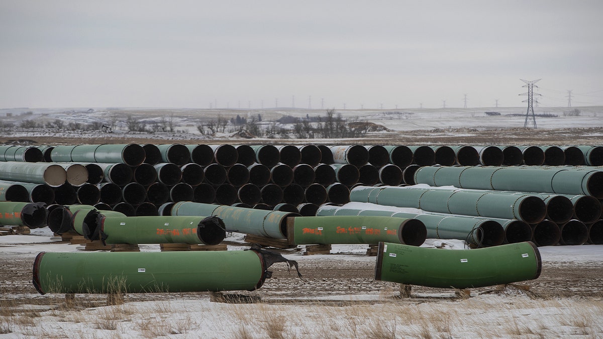 Pipes for the Keystone XL pipeline are stacked in a yard near Owen, Alberta, Canada, on Tuesday, January 26, 2021.