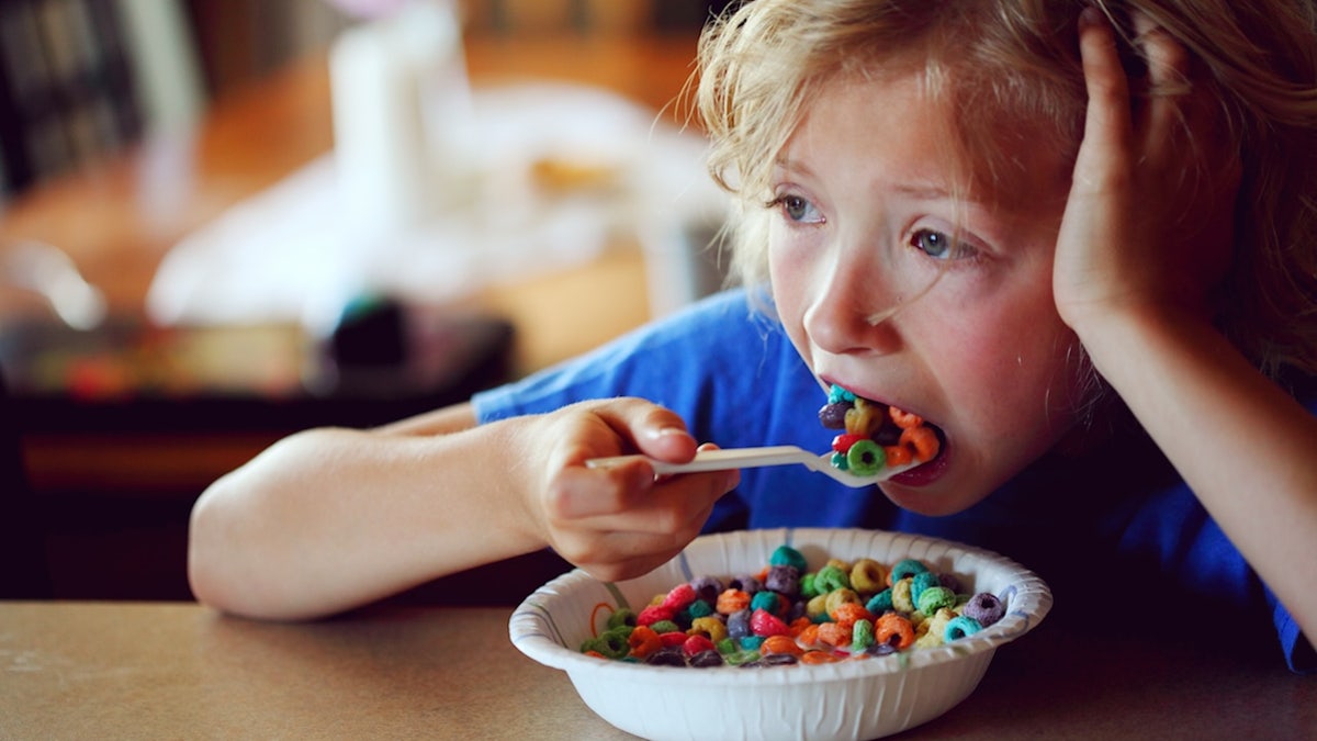 child eating sweet cereal