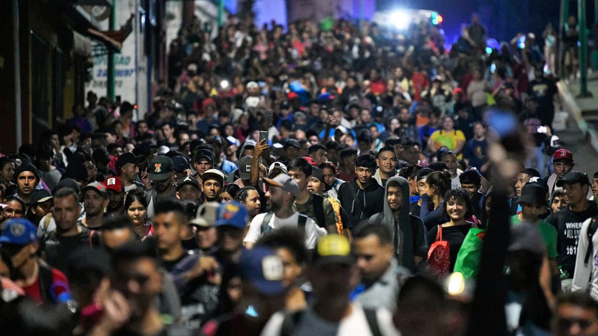 Migrants from a caravan in Tapachula, Chiapas state, Mexico, march while heading to the US border