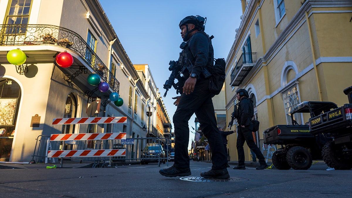 Police walk at Bourbon Street crime scene