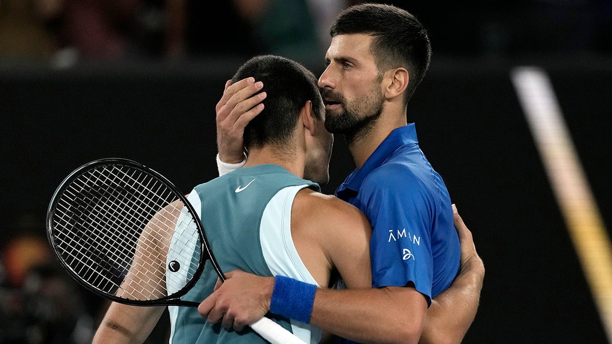 Novak Djokovic hugs Carlos Alcaraz