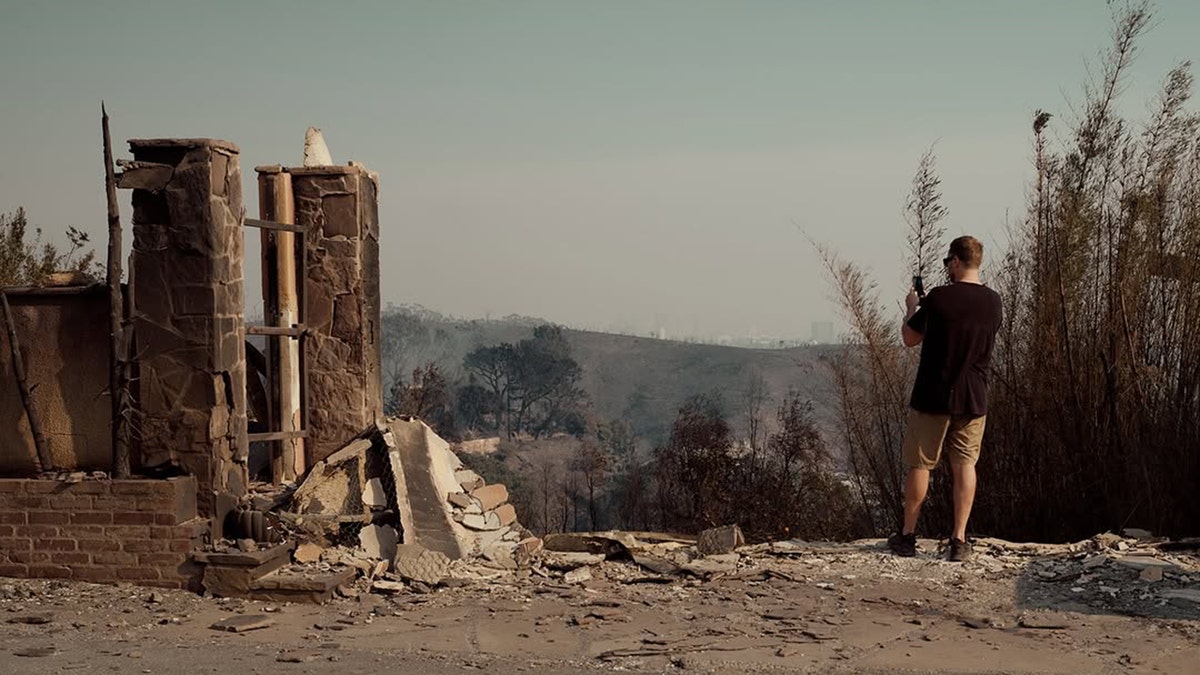 Spencer Pratt surveying his burned down home