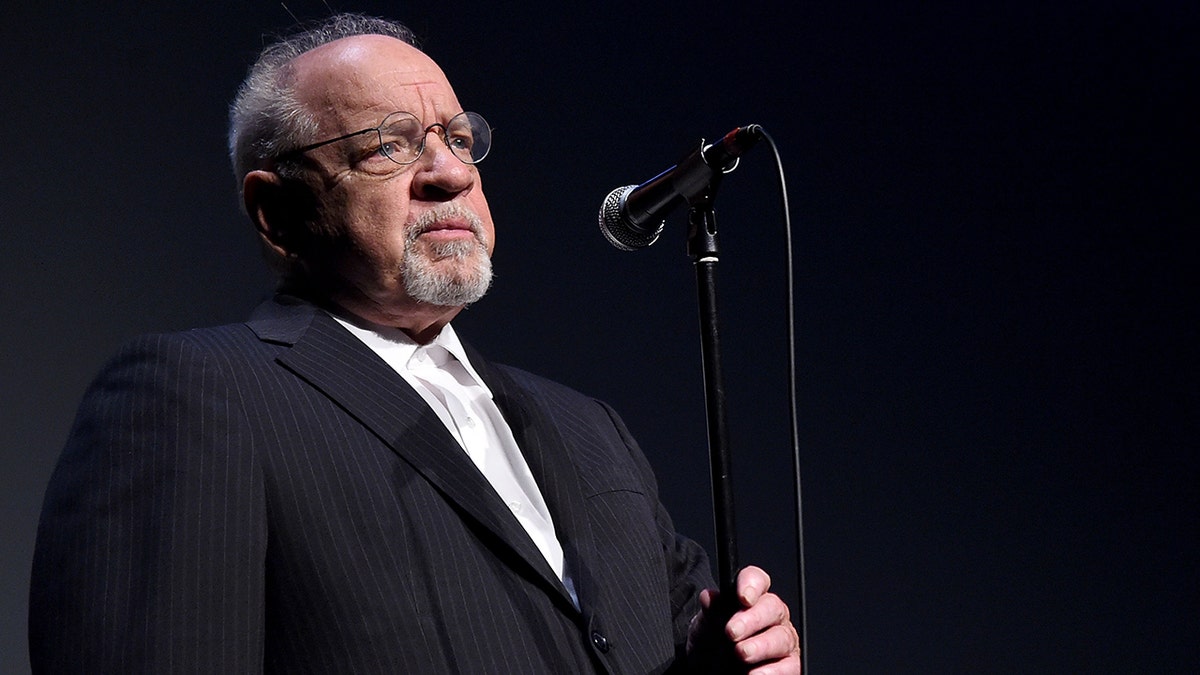 Paul Schrader standing at microphone