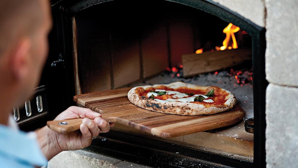 A wooden peel is ideal for launching your pizza into the oven.