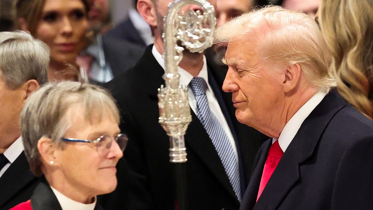 Donald Trump stands adjacent   Reverend Mariann Edgar Budde