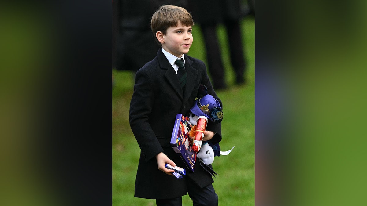 Prince Louis holding his presents during the Christmas morning walkabout.